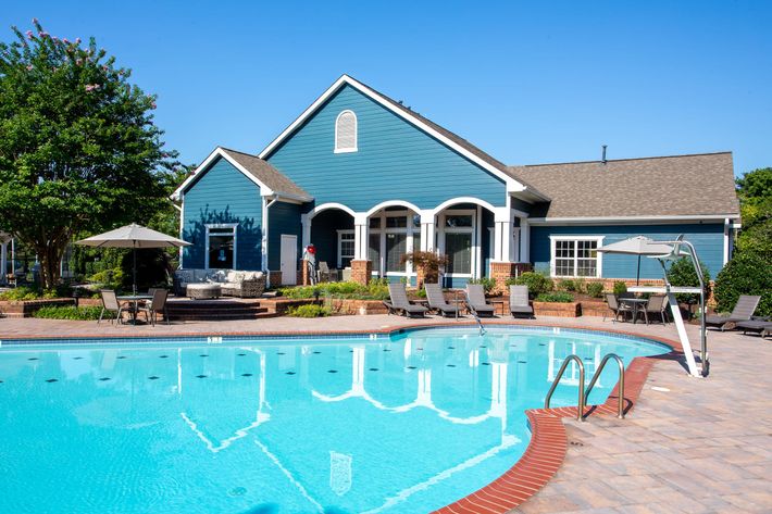 a house with a pool in front of a building