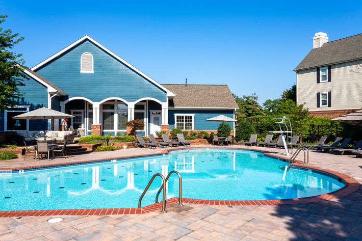 a large pool of water in front of a house