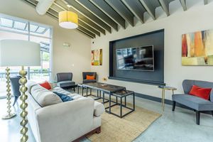 furnished community room with a TV