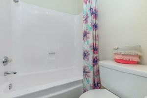 Bathroom with multi-colored shower curtain