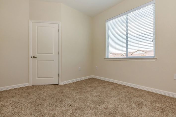 a bedroom with a large window