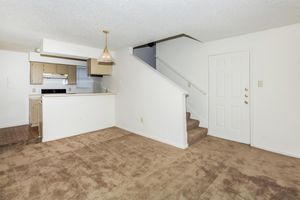 carpeted apartment with stairs