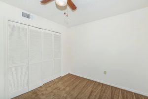 bedroom with accordion closet doors