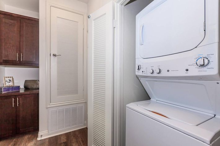 a white refrigerator freezer sitting next to a door
