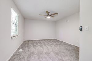 Empty townhome platinum bedroom interior with fresh carpeting at The Arbor in Blue Springs, Missouri