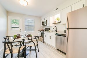 Kitchen table and stainless steel appliances at The Arbor in Blue Springs, MO
