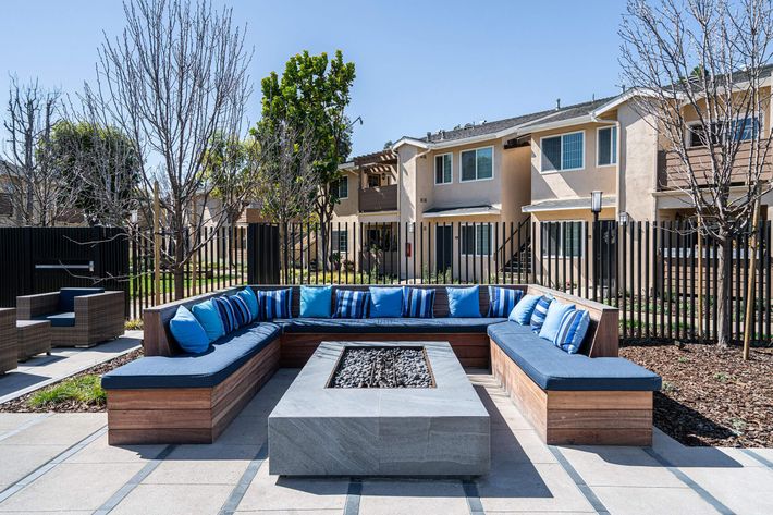 blue couch and pillows surrounding a fire pit