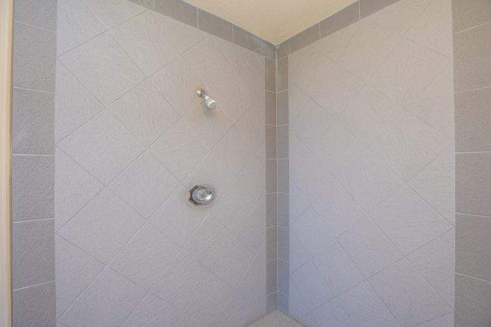 shower area with grey tiles