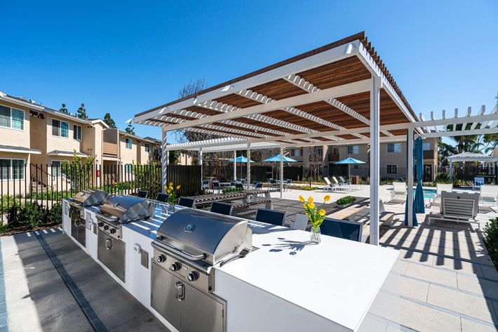 stainless steel barbecues next to a pergola