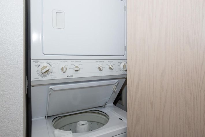 a white stove top oven sitting next to a door