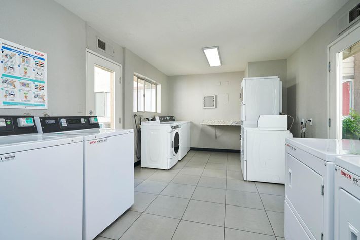 a kitchen with a white refrigerator freezer sitting in a room