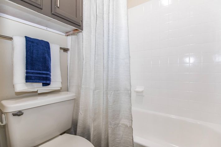 a shower curtain next to a tub