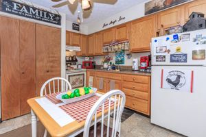 a kitchen with wooden cabinets and a table
