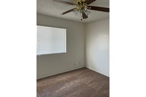 Vacant bedroom with a ceiling fan