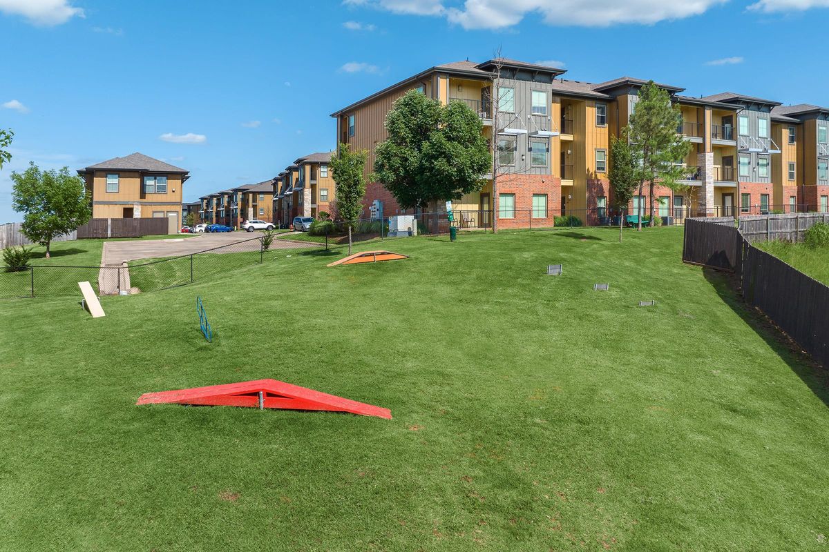 a yard with a kite in front of a building