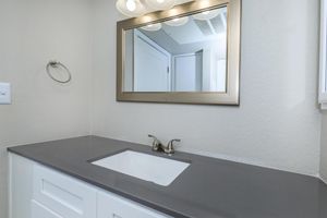 a white sink and a mirror