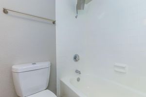 a white tub sitting next to a sink