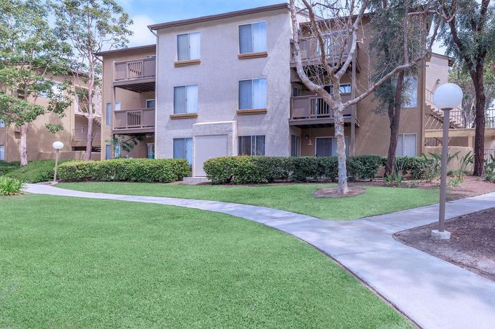 Trabuco Woods Apartment Homes community building with green grass