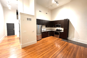 a kitchen with a hard wood floor