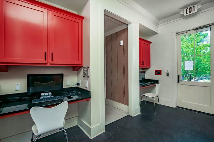 a kitchen with a red door