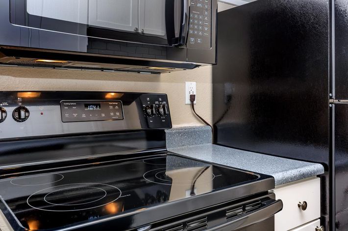 a microwave oven sitting on top of a stove