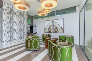 Modena community room with green chairs