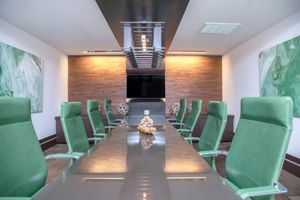 Modena business room with green office chairs 