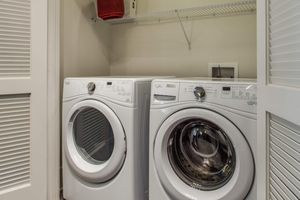 white washer and dryer in the laundry closet