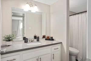 Renovated bathroom vanity next to toilet and shower