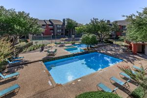 One Townecrest community pool with green trees and shrubs