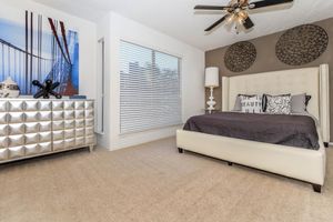 carpeted bedroom with a sliver dresser