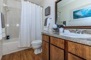 furnished bathroom with a white shower curtain