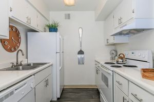 Galley way kitchen with white cabinets, white cabinets, and kitchen decor