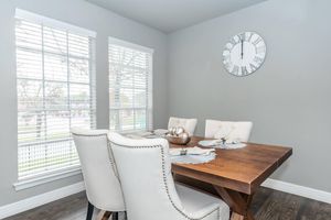 a living room with a clock on a table