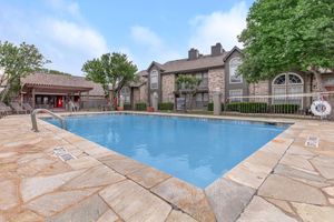 the community pool with green trees