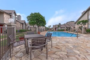 a community pool with a table and chairs