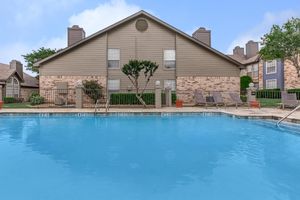 Plano Park community pool with green trees