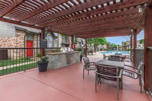 stainless steel barbecue under a pergola