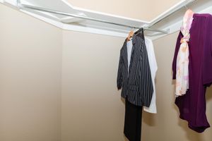 walk-in closet with clothes