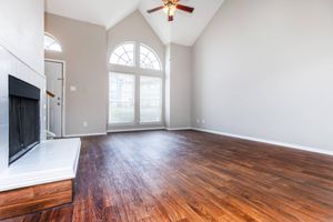 vacant living room with wooden floors