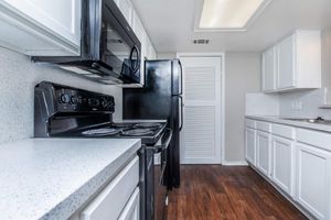 vacant kitchen with black appliances