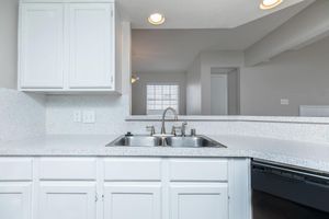 kitchen sink with white cabinets