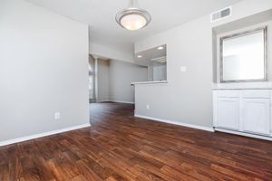 vacant dining room with a mirror