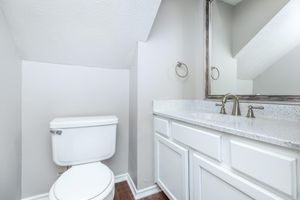 vacant bathroom with grey countertops