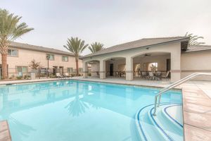 Masterpiece Parke community pool with tables and chairs