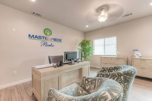 Masterpiece Parke leasing office with green chairs