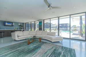 Large mid-century modern apartment clubhouse with floor to ceiling windows and lounge area