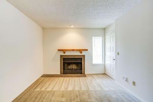 Living Room with a Cozy Fireplace - Rainbow Ridge Apartments - Kansas City - Kansas