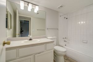 Bathroom with vanity and modern lighting at Rainbow Ridge Apartments in Kansas City, Kansas