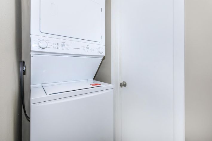 a microwave oven sitting on top of a refrigerator